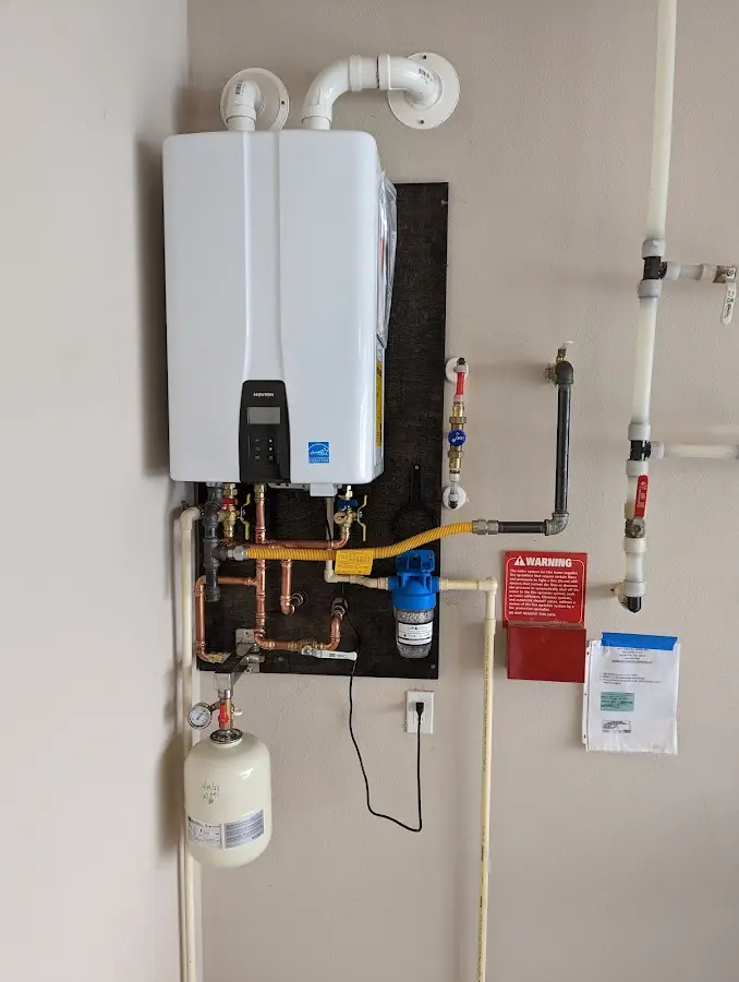 Professional plumber installing copper piping in a West Point home